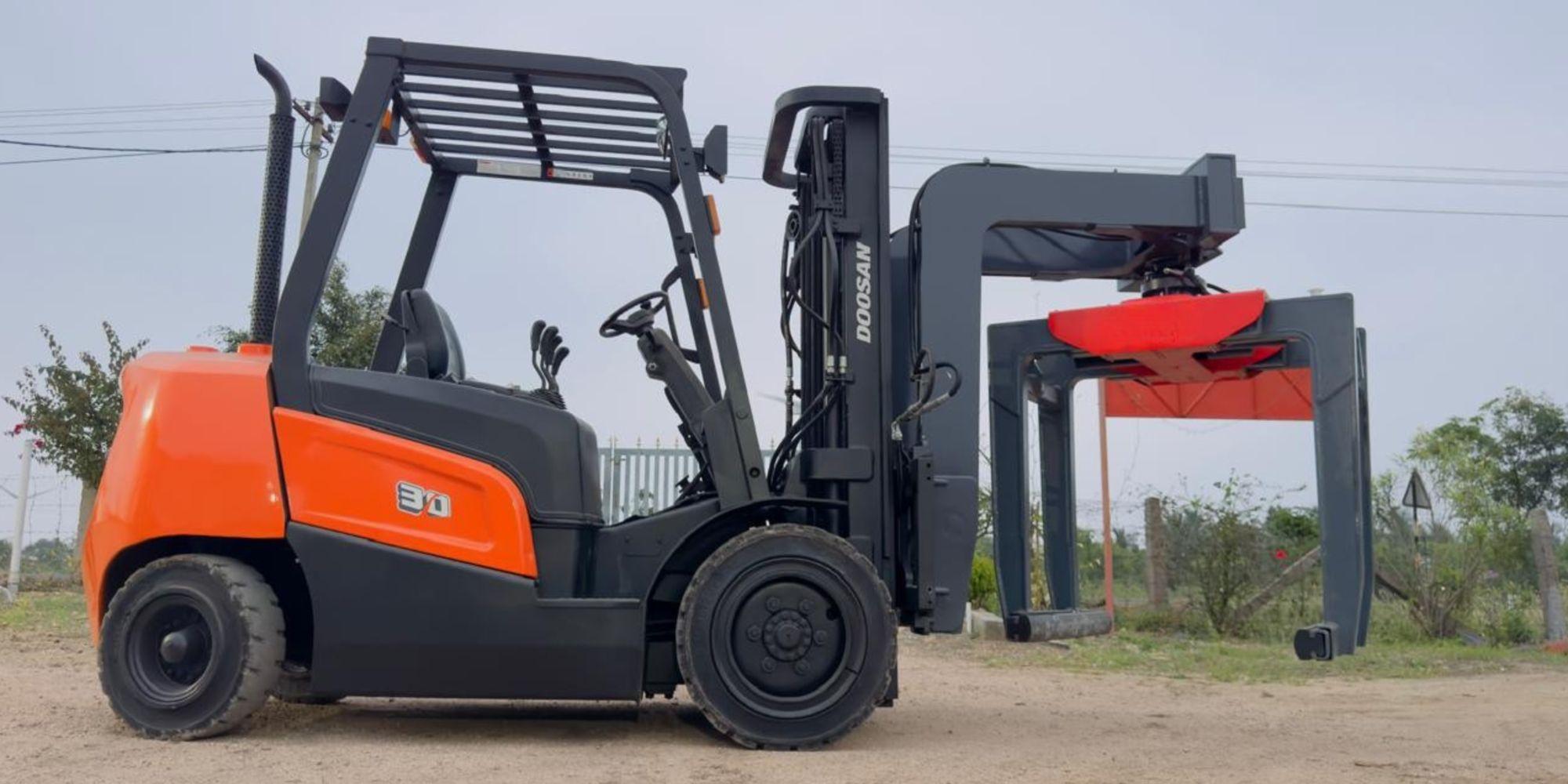 Brick grabber on a forklift stacking hollow blocks in a block yard